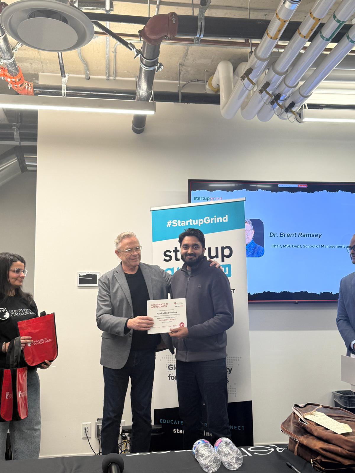 PixelPaddle Solutions receiving a certificate of appreciation