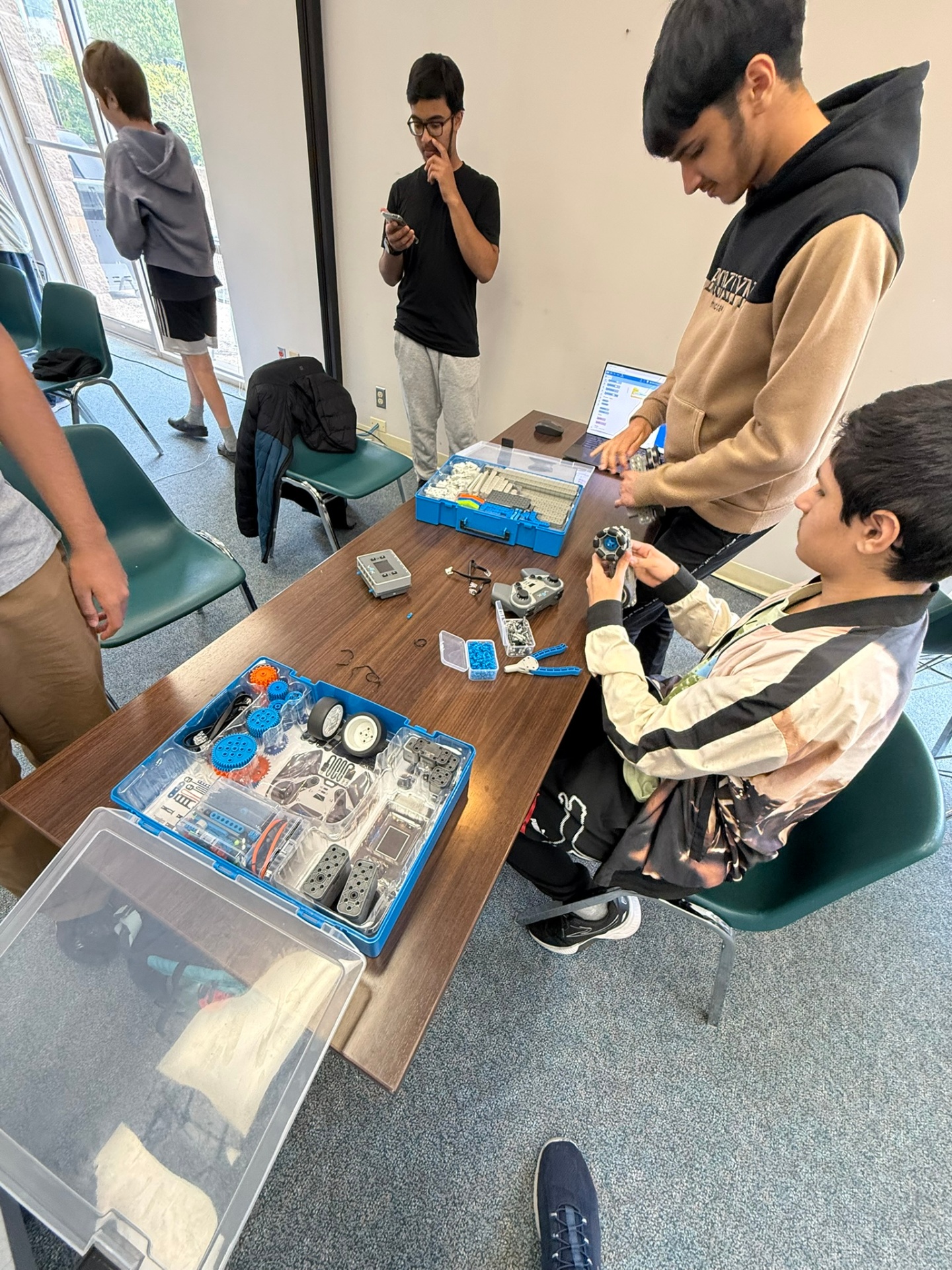 Students exploring robotics kits during a hands-on session