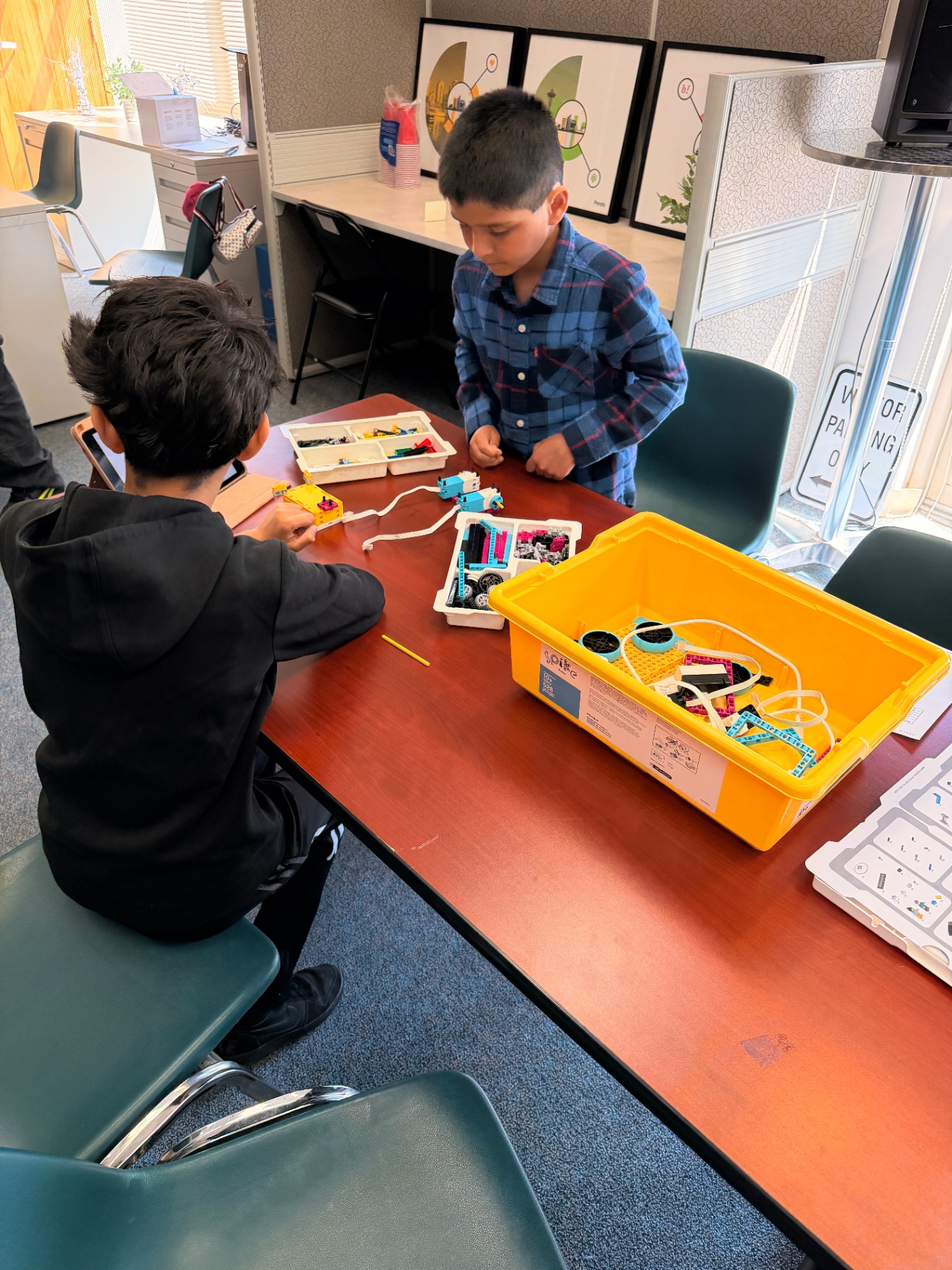 Young learners building with LEGO Spike robotics kits