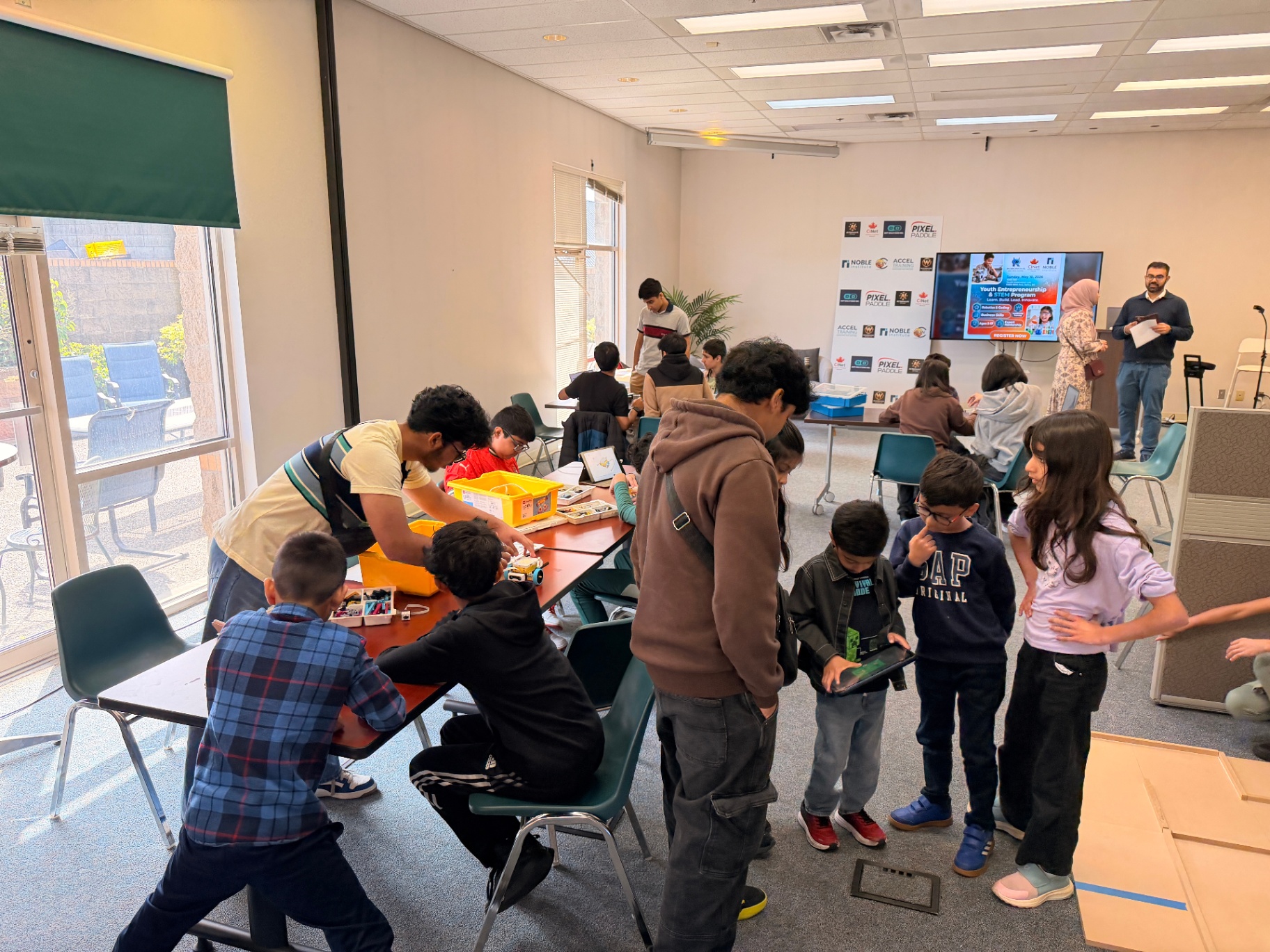 Active classroom of youth innovators with mentors and parents
