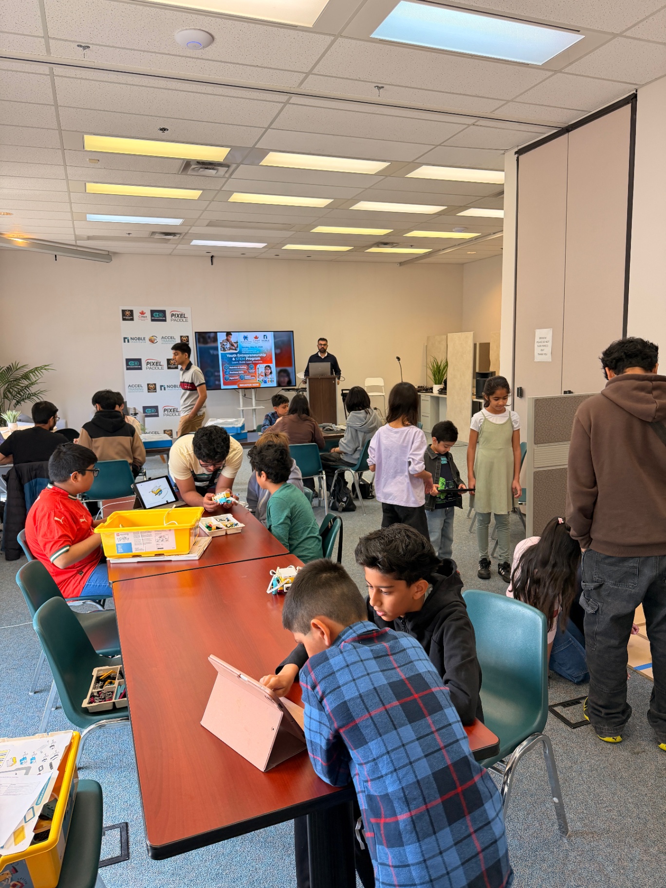 Students collaborating across multiple stations on STEM challenges